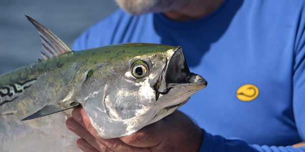 angler wearing Hook Life shirt with fish
