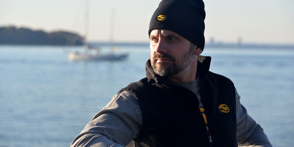 man wearing Hook Life with harbor in background