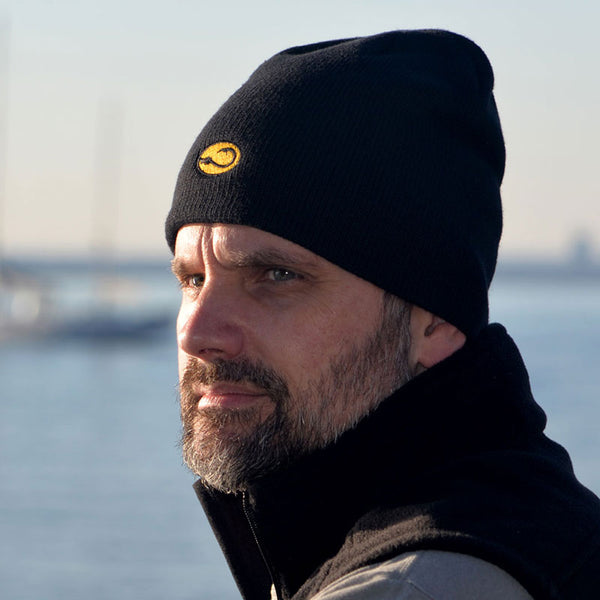 man in black fishing Watch Cap by Hook Life at a harbor
