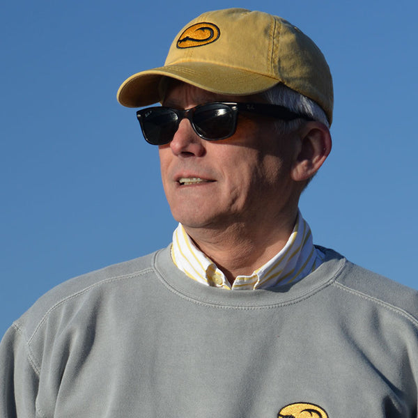 man wearing yellow Hook Life Beach fishing cap