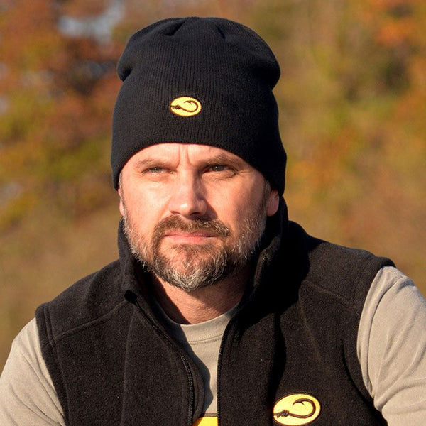 man wearing black fishing Watch cap by Hook Life with fall foliage