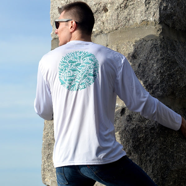young man climbing seawall in white performance fishing shirt by Hook Life